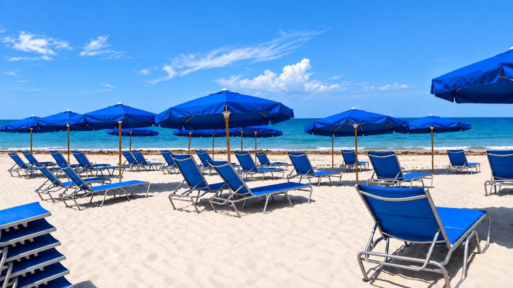 Royal blue beach umbrellas and sling lounges on white sand